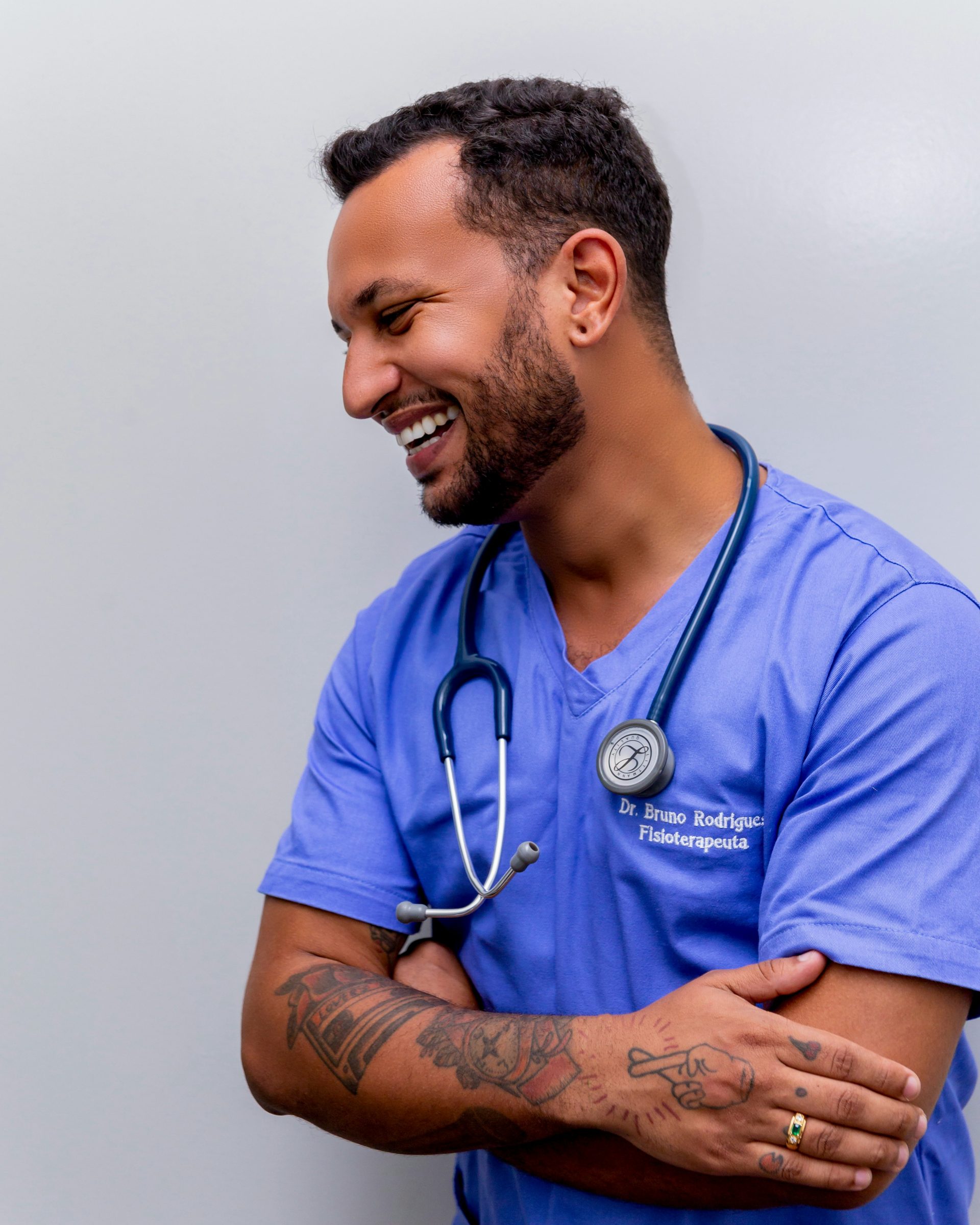 man in blue scrub suit wearing blue stethoscope